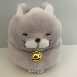 Light grey cat with a bell plushie